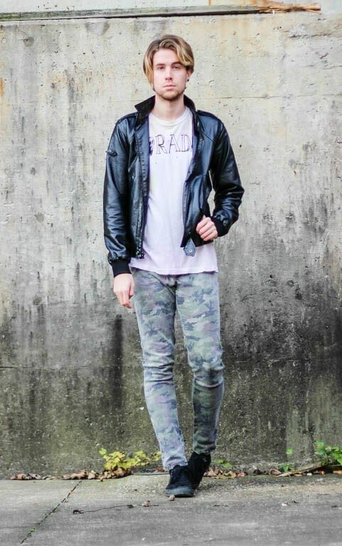 The Kentucky Gent in Rad T-Shirt by UNIF, Black Apple Leather Jacket, Tripp NYC Camo Rocker Pants, and Black Chucks by Converse