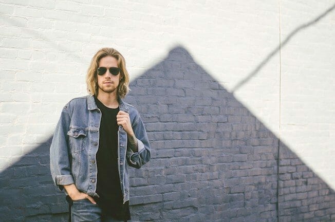 The Kentucky Gent, a men's fashion and lifestyle blogger, in Zanerobe Flintlock T-Shirt, Levi's 511 Jeans, Levi's Denim Jacket, Richer Poorer Socks, Ray-Ban Aviator Sunglasses, and CAT Footwear boots.