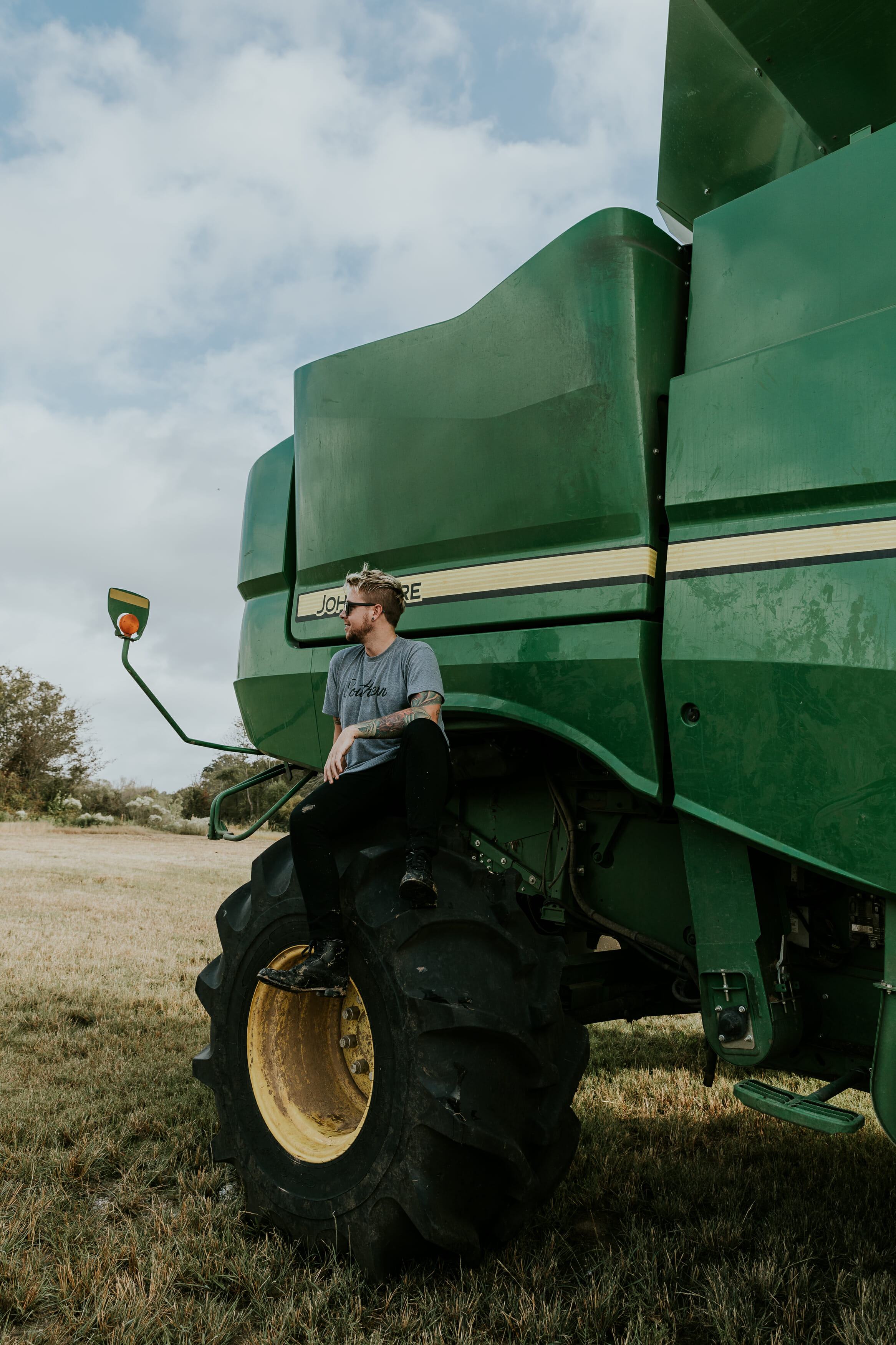 guy sitting on john deer tractor