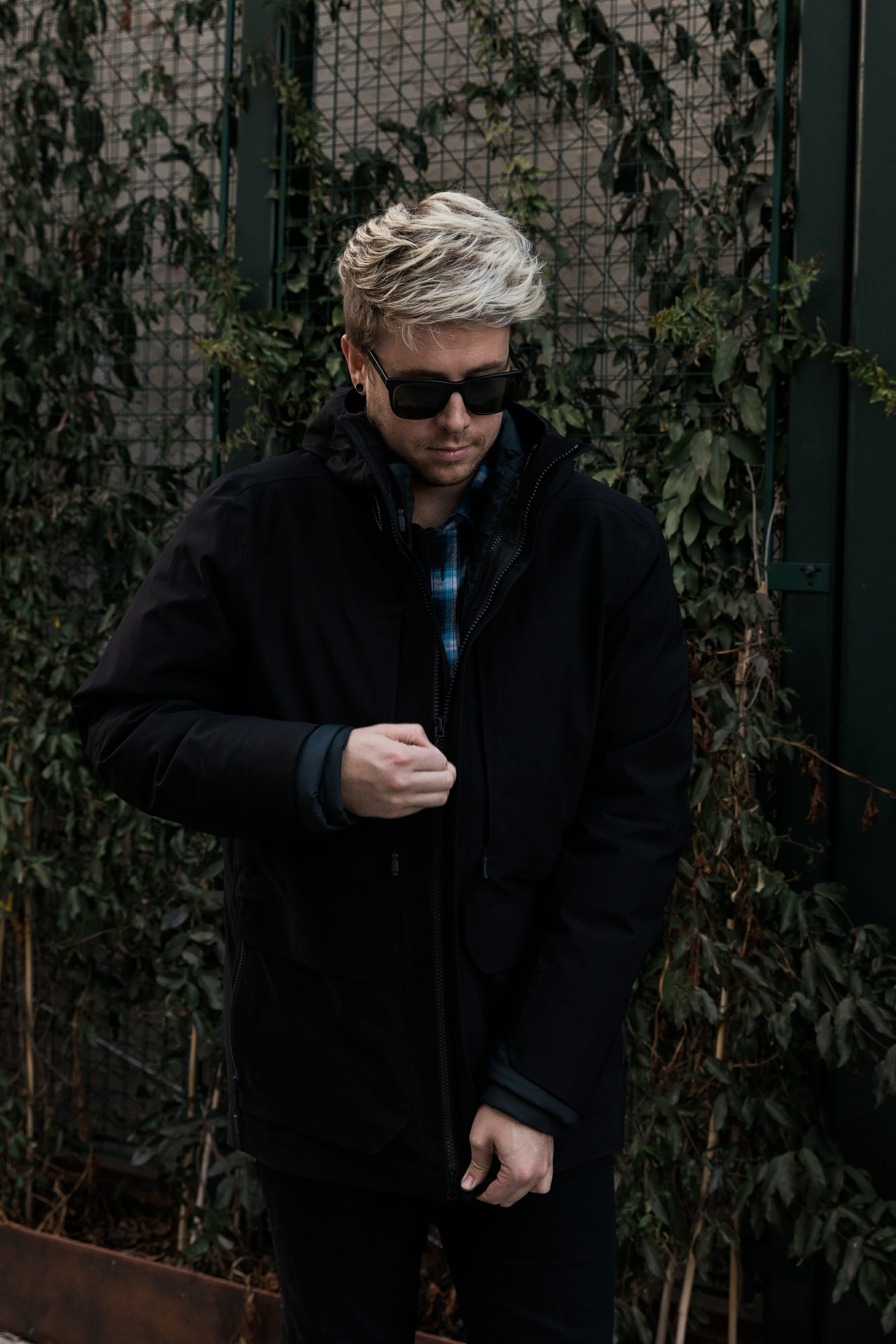 blonde man zipping jacket