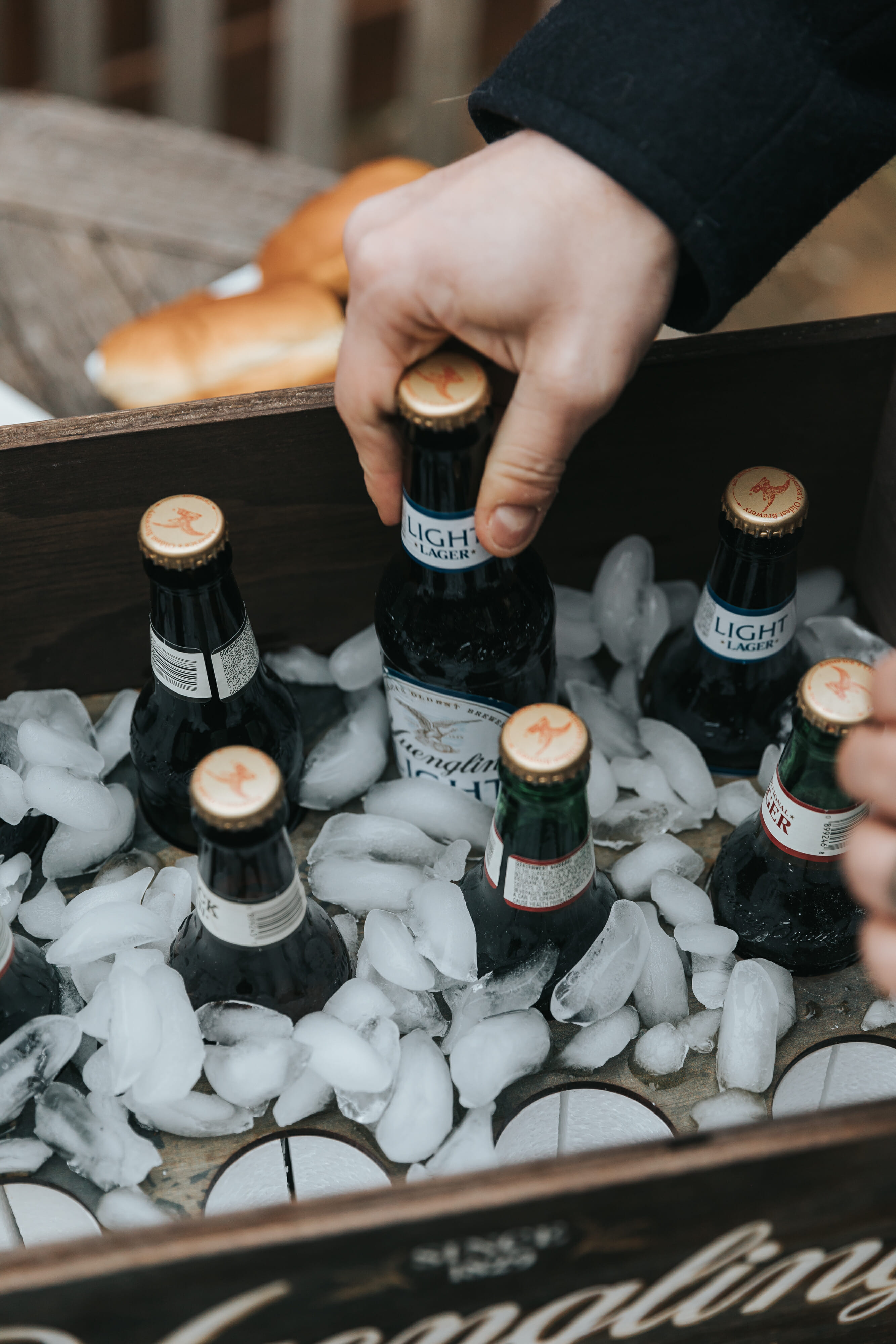 man reaching for yuengling beer