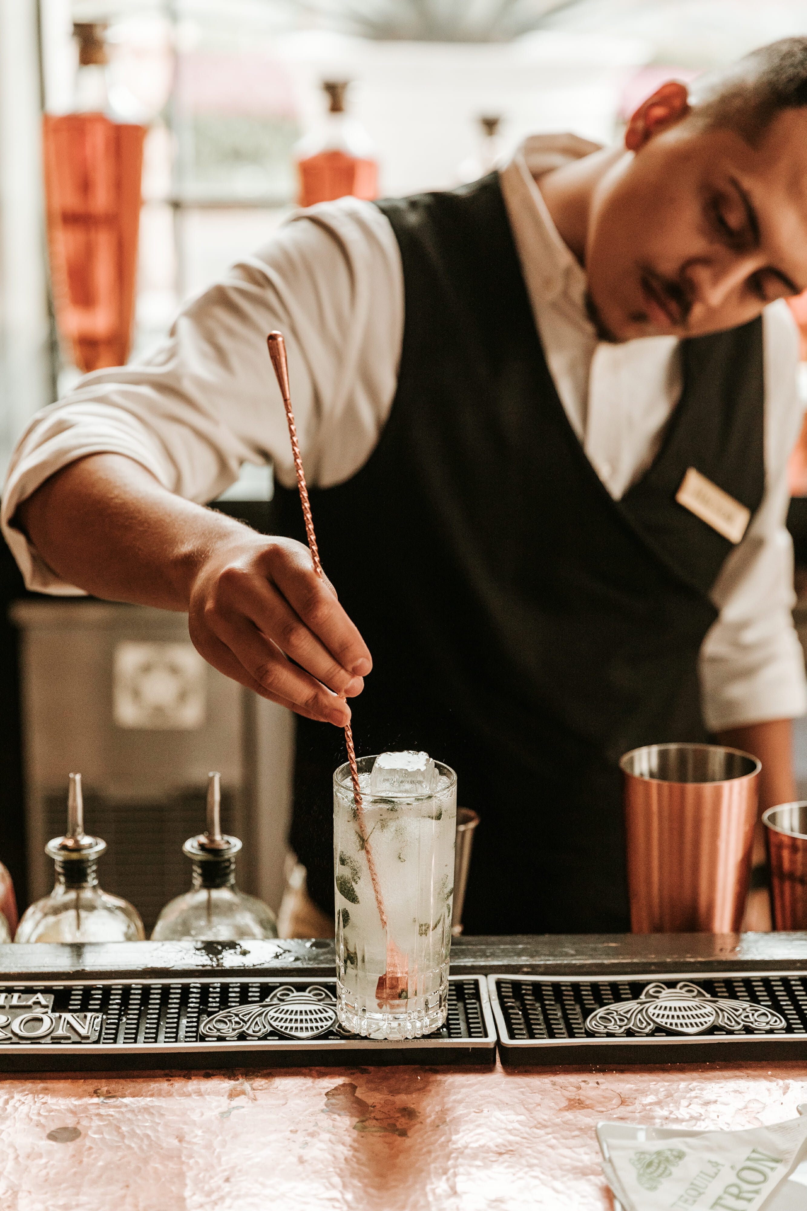 man stirring cocktail