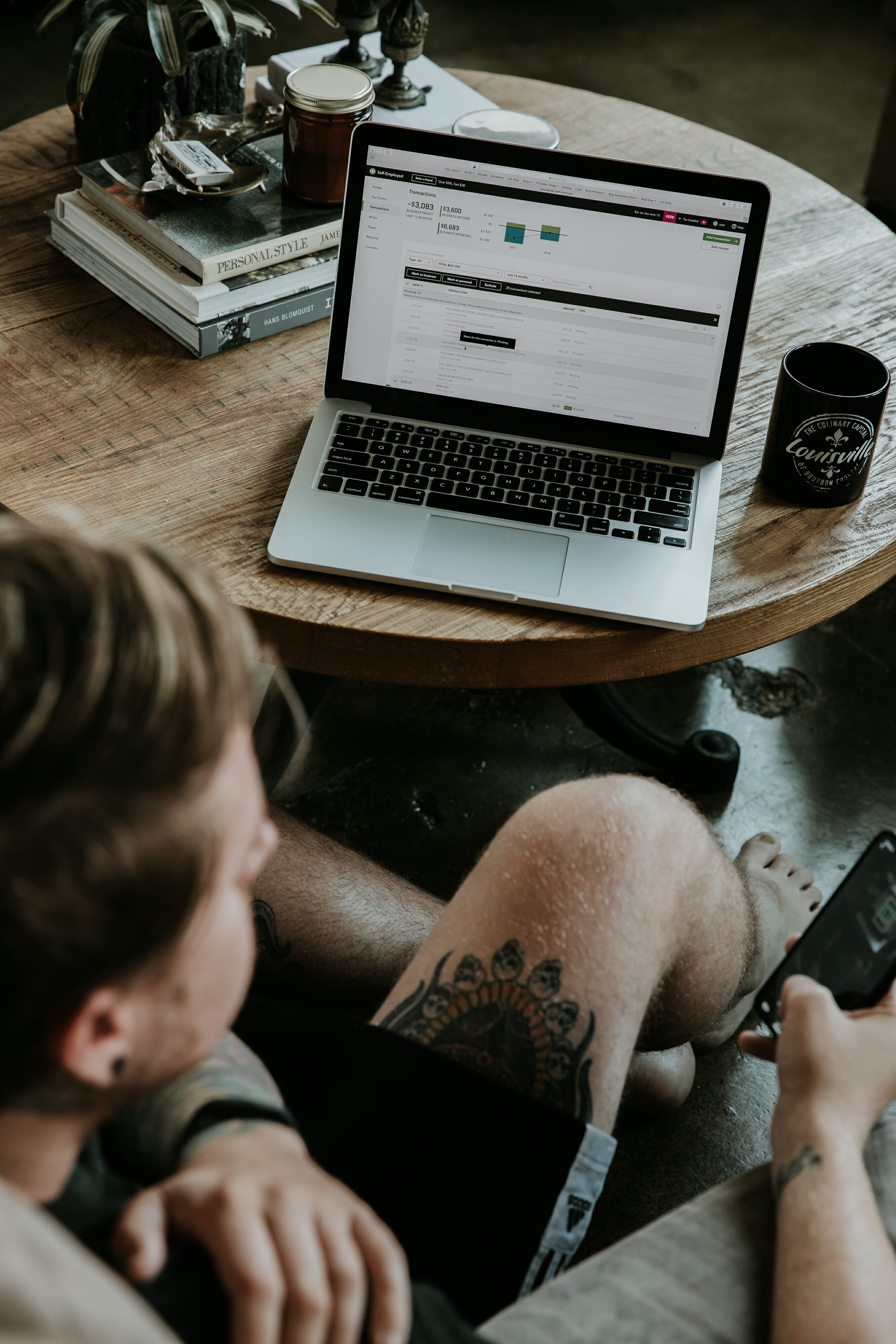 man sitting in floor on phone