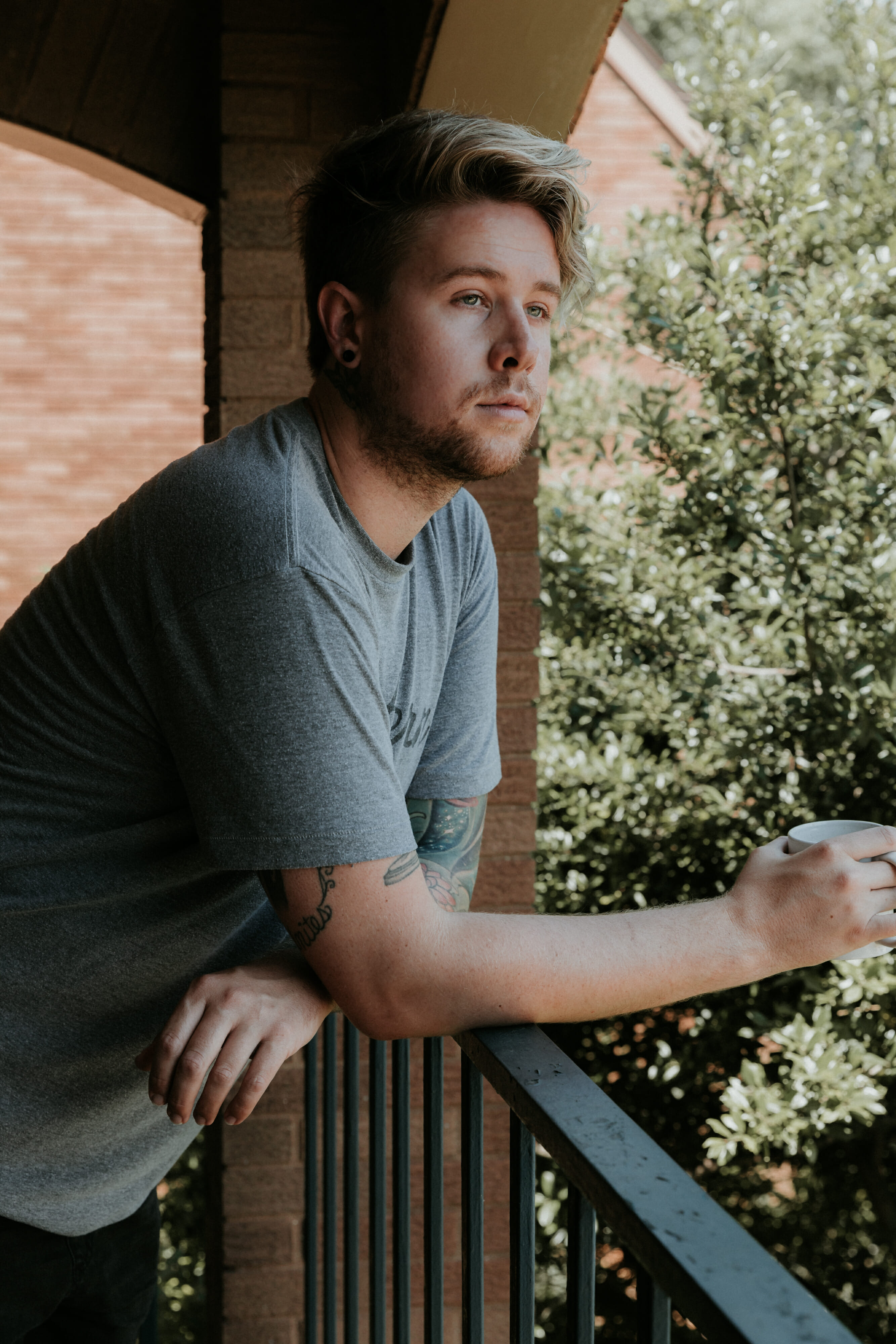 man on balcony at Hurstbourne Grand Apartments