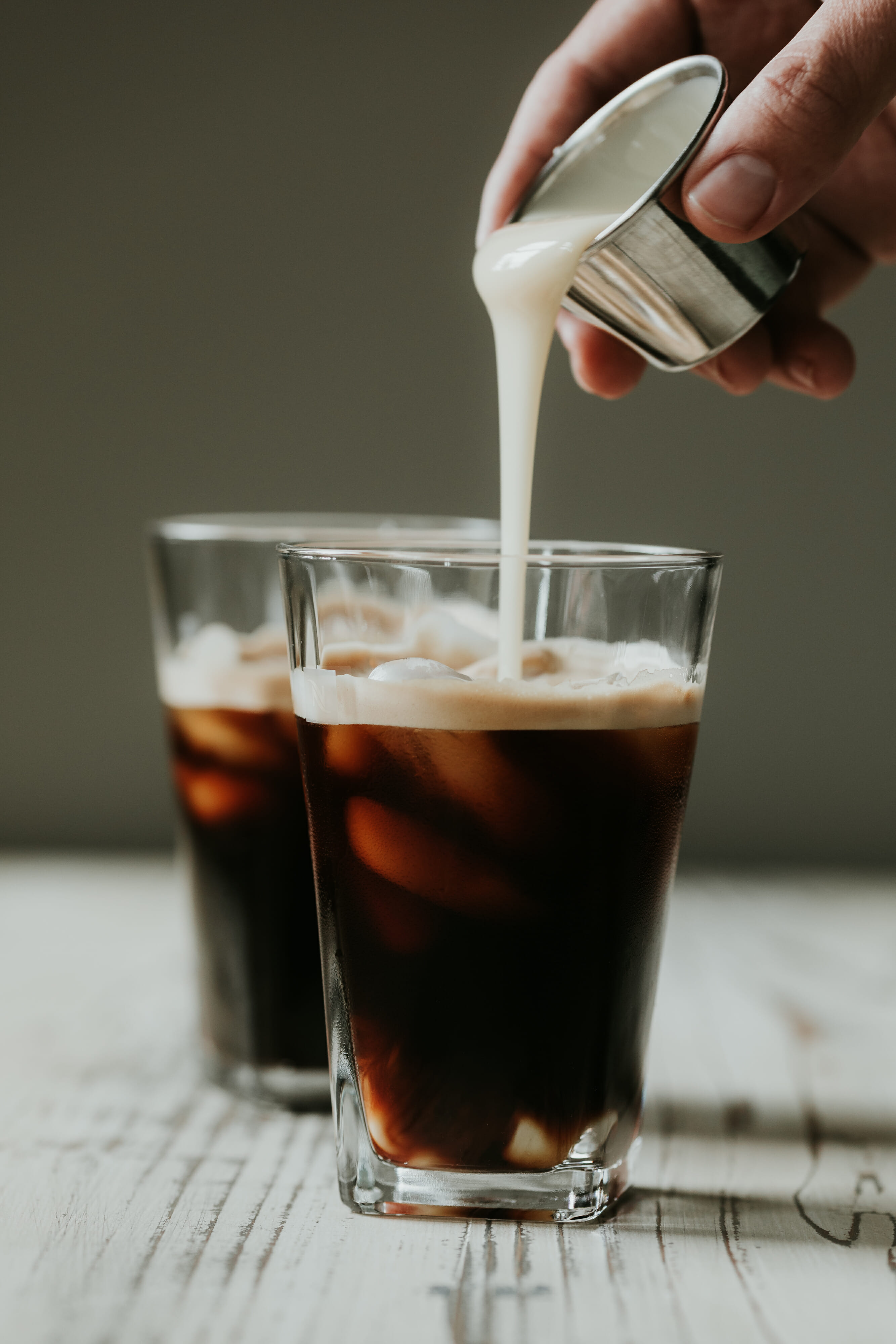 pouring milk into coffee