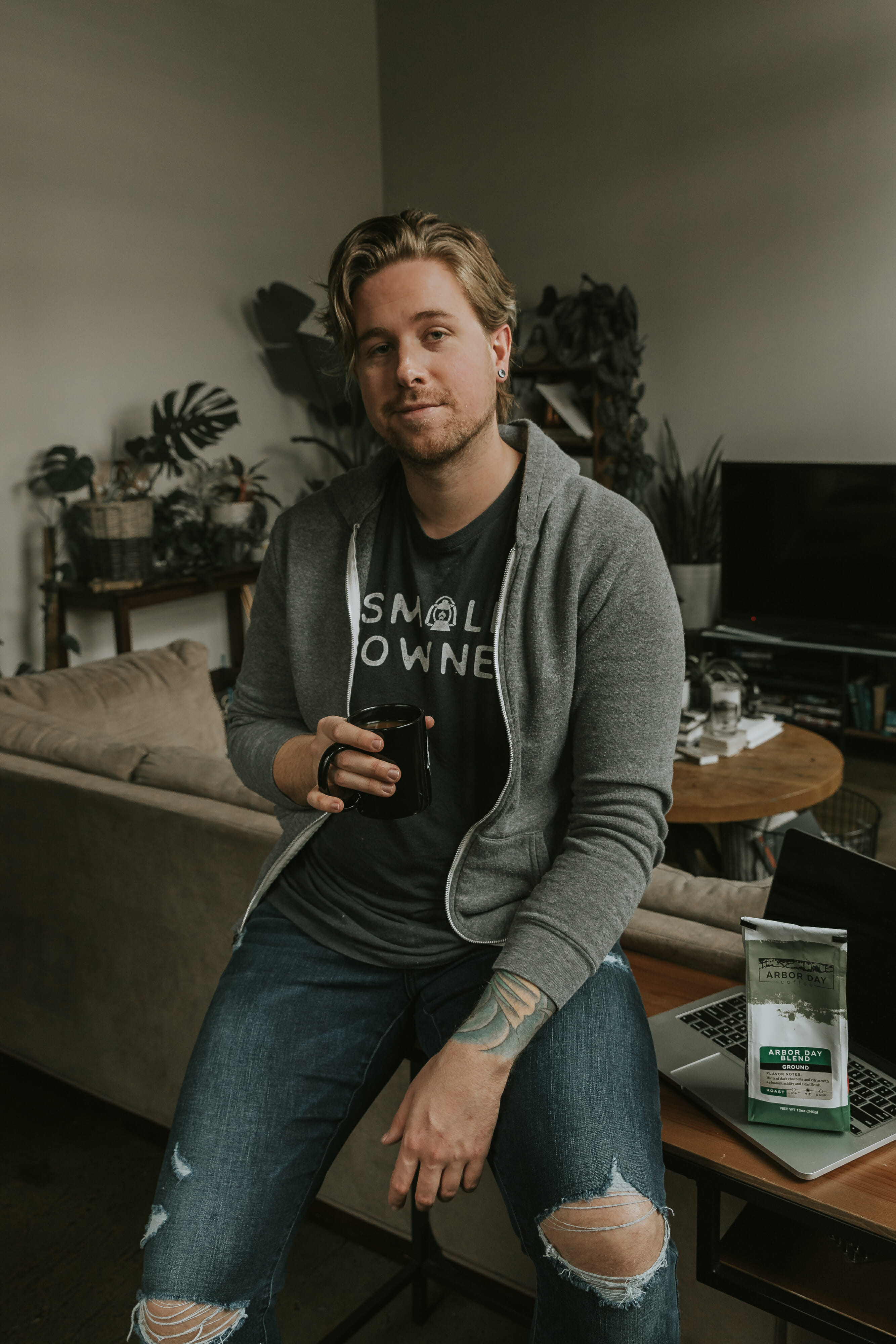 blonde man holding coffee cup 