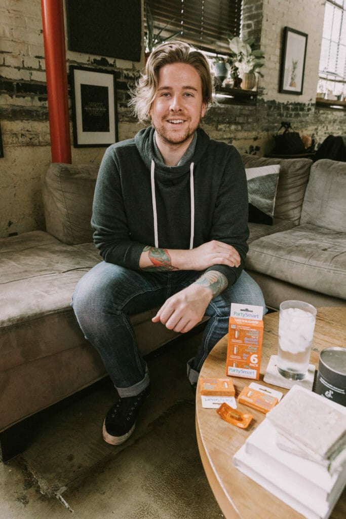 blonde man sitting on couch