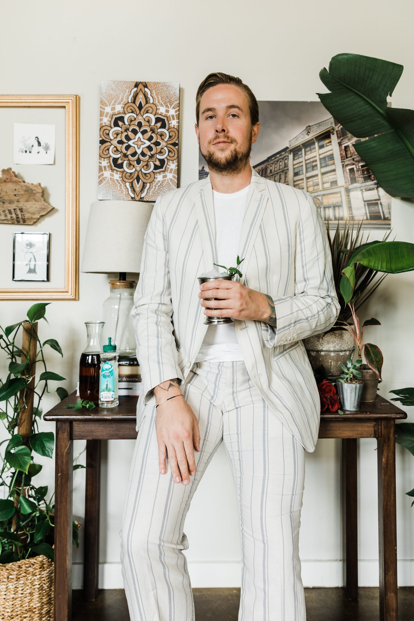 man in white suit with mint julep