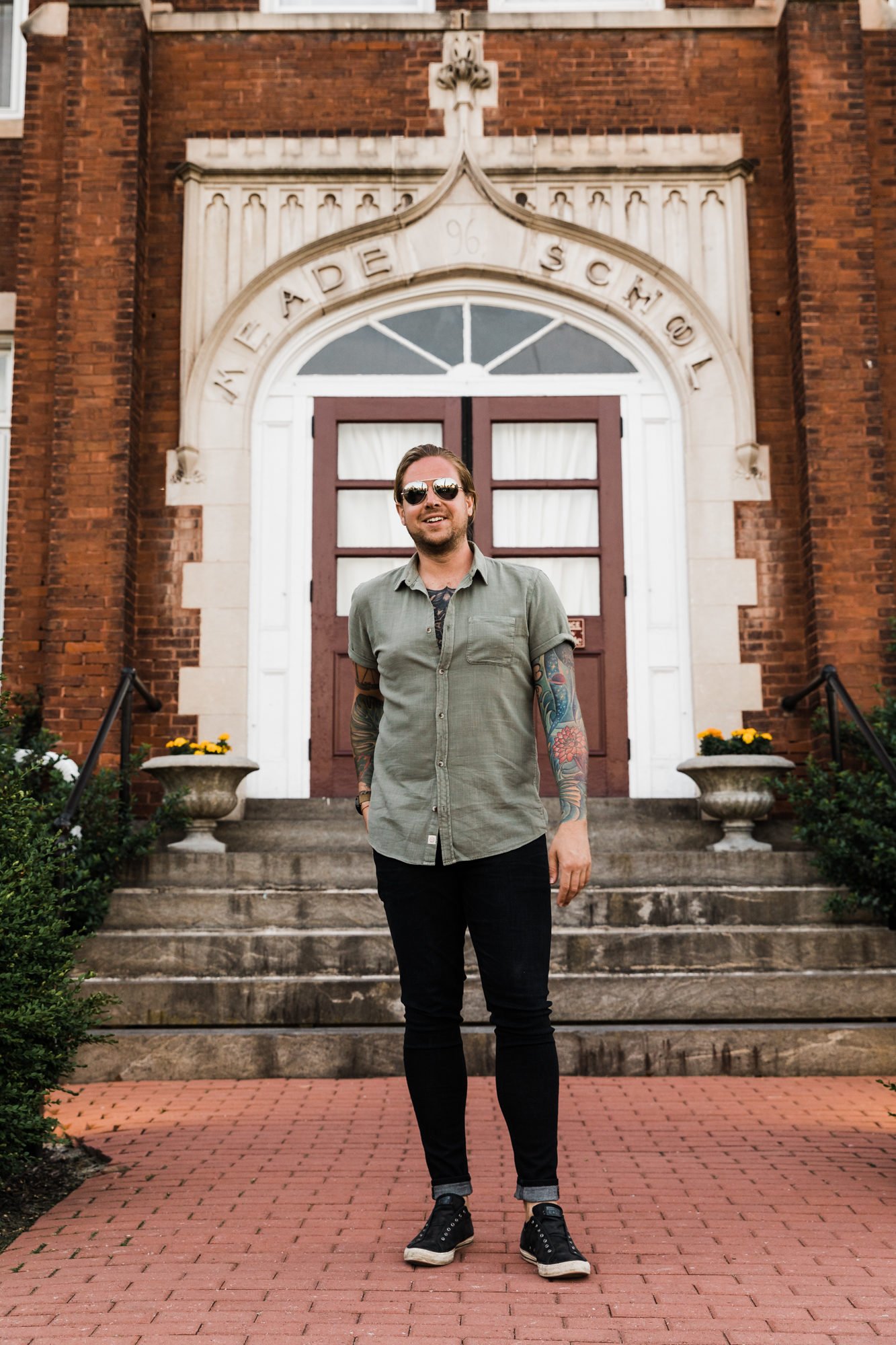 man in black jeans and green shirt