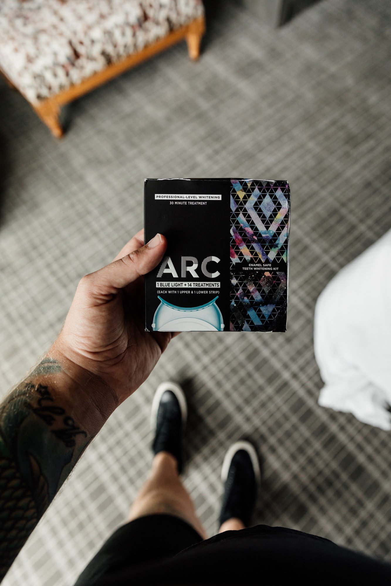 man holding arc teeth whitening kit