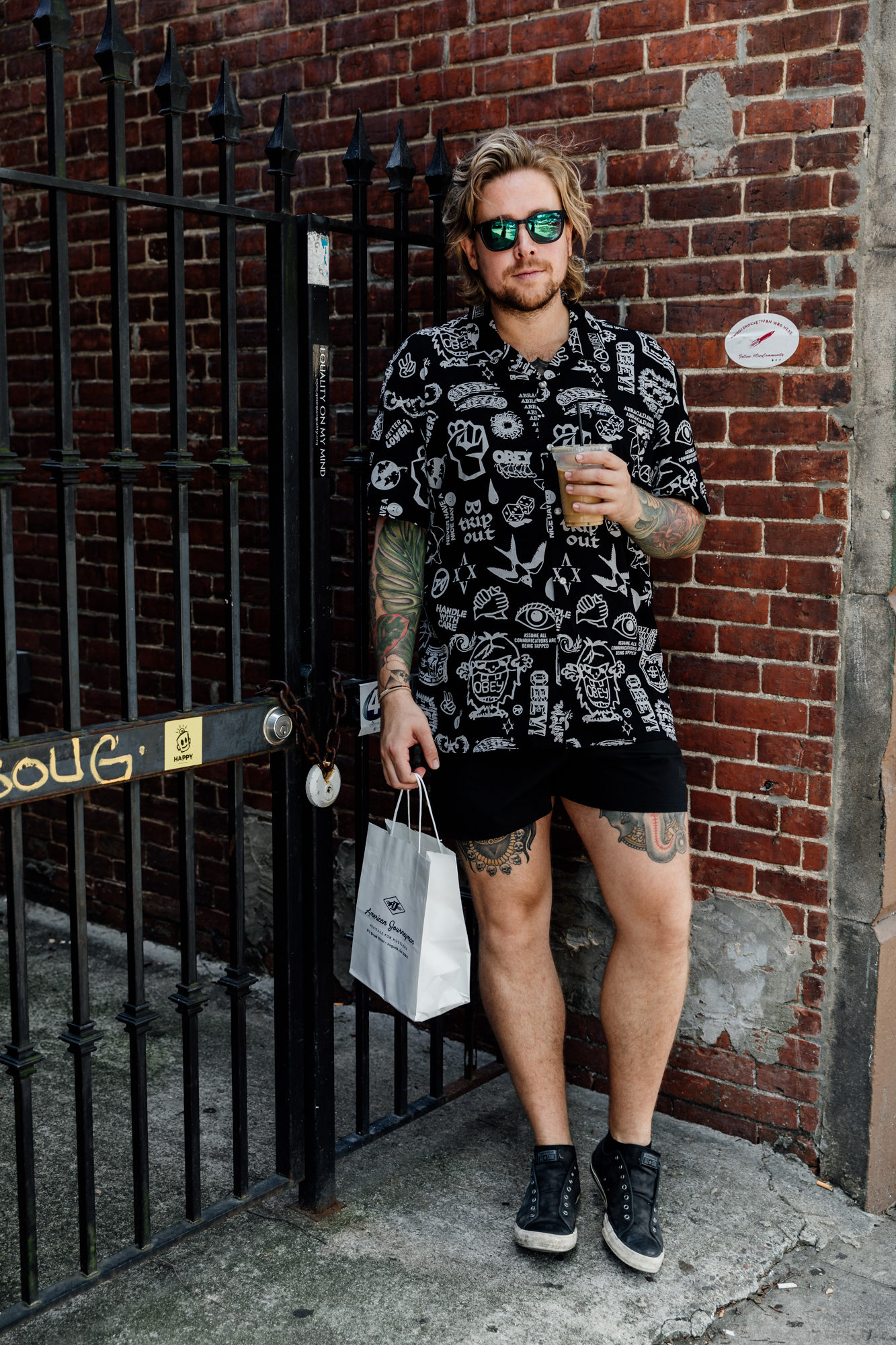 man with coffee and shopping bag