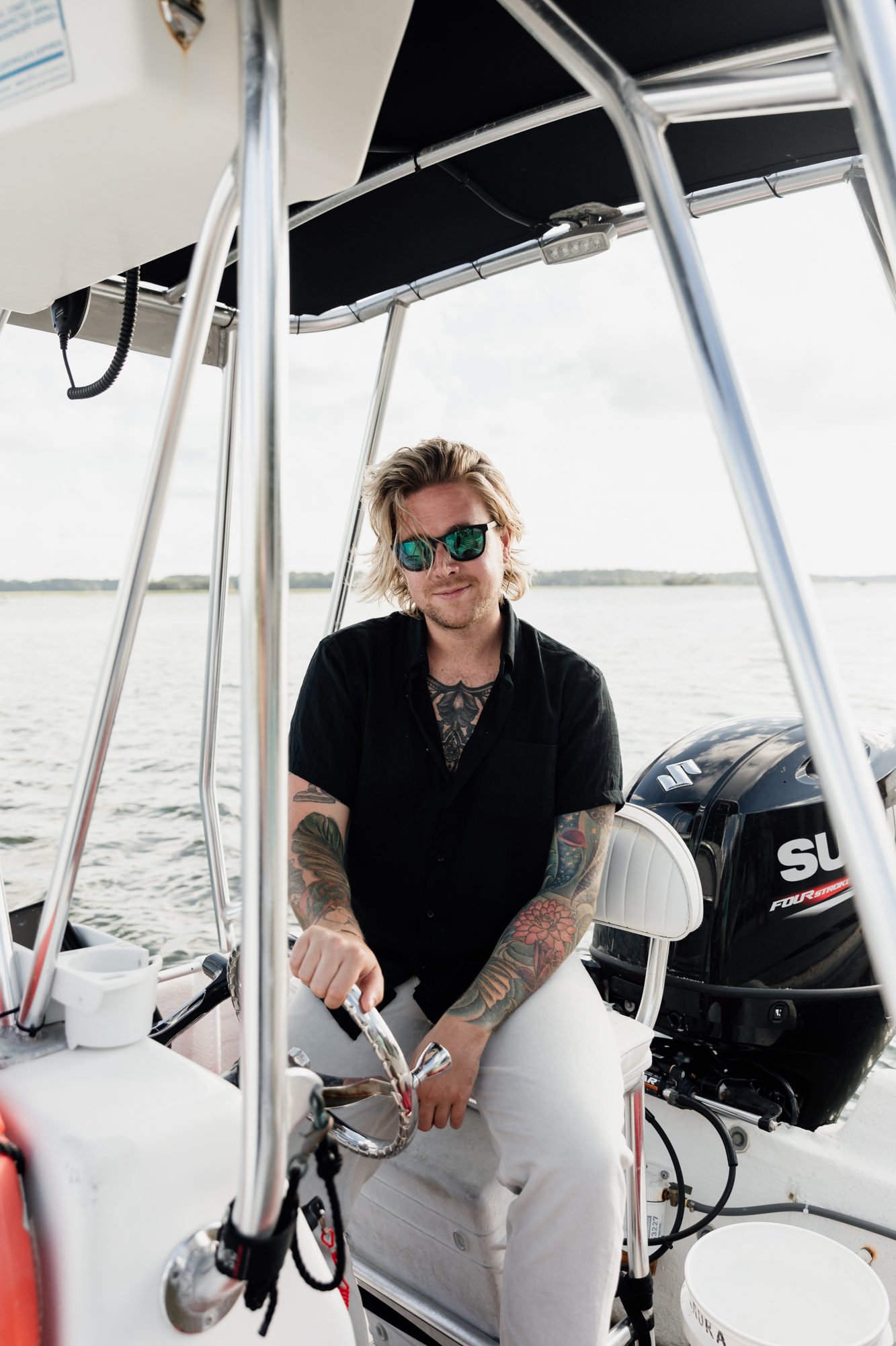 blonde man driving boat